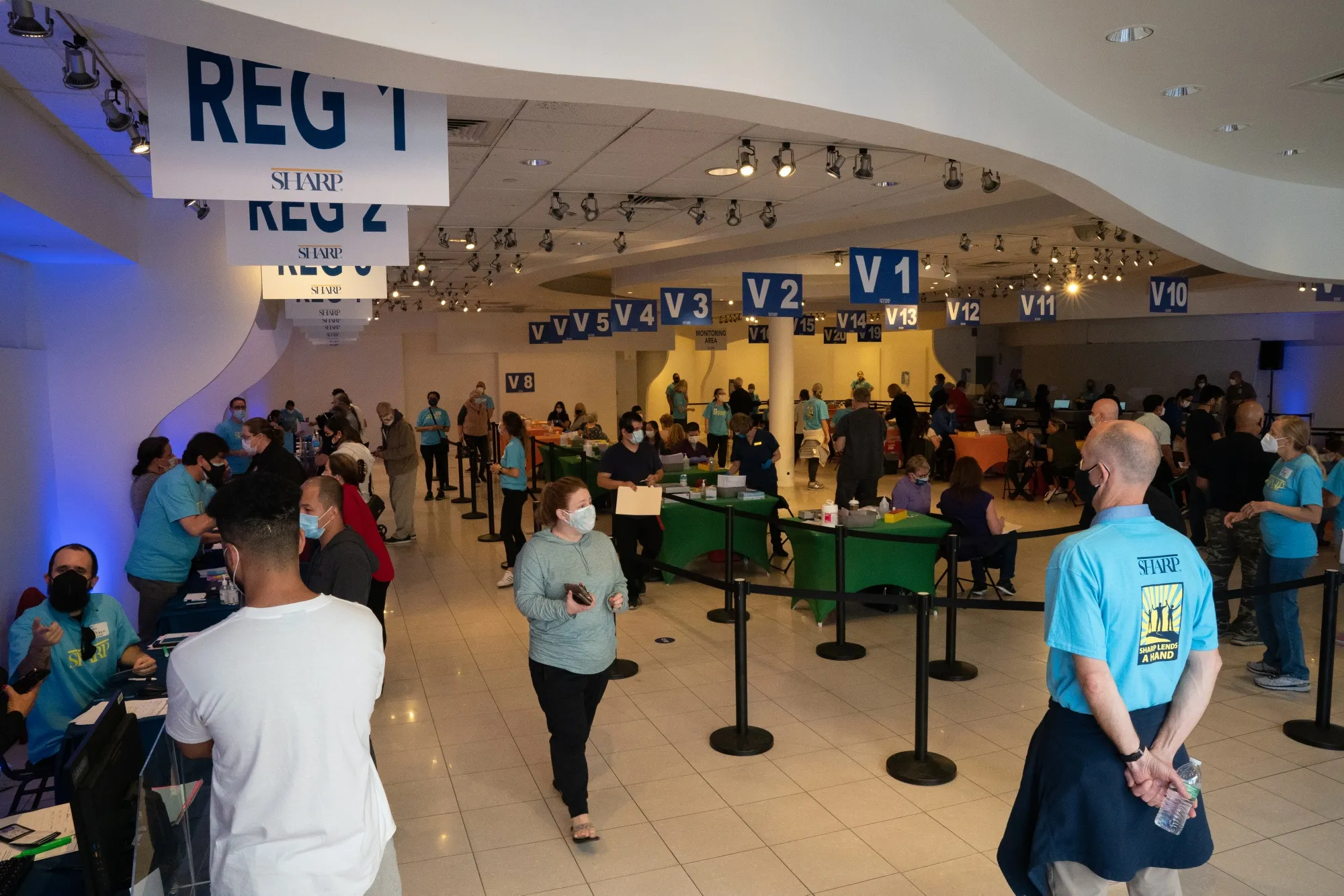 Volunteers assist people at a Sharp HealthCare mass vaccination super site inside the Grossmont Center Mall in La Mesa, California on Feb. 11.