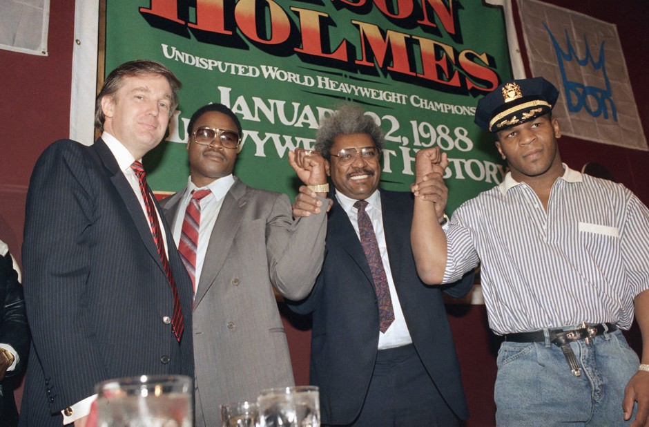 Donald Trump with Don King, who holds the wrists of world heavyweight champion Mike Tyson (far right) and his challenger Larry Holmes in 1988.