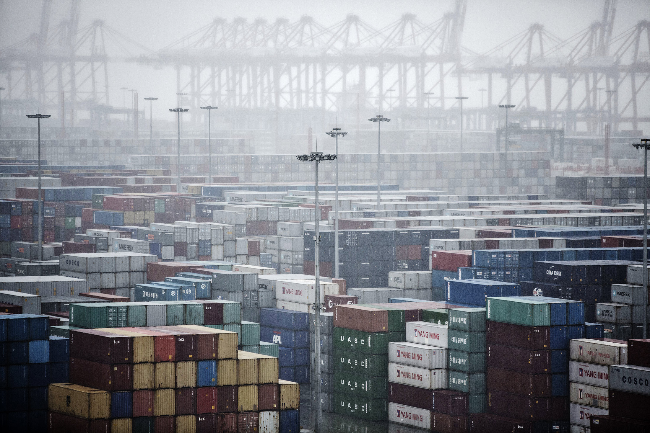 Shipping containers stacked at the Guangzhou Nansha Container Port are seen from CMA CGM SA's Benjamin Franklin container ship docked at the terminal in Guangzhou, China, on Monday, Feb. 1, 2016. The Benjamin Franklin is the largest container ship ever to have docked at a U.S. port.
