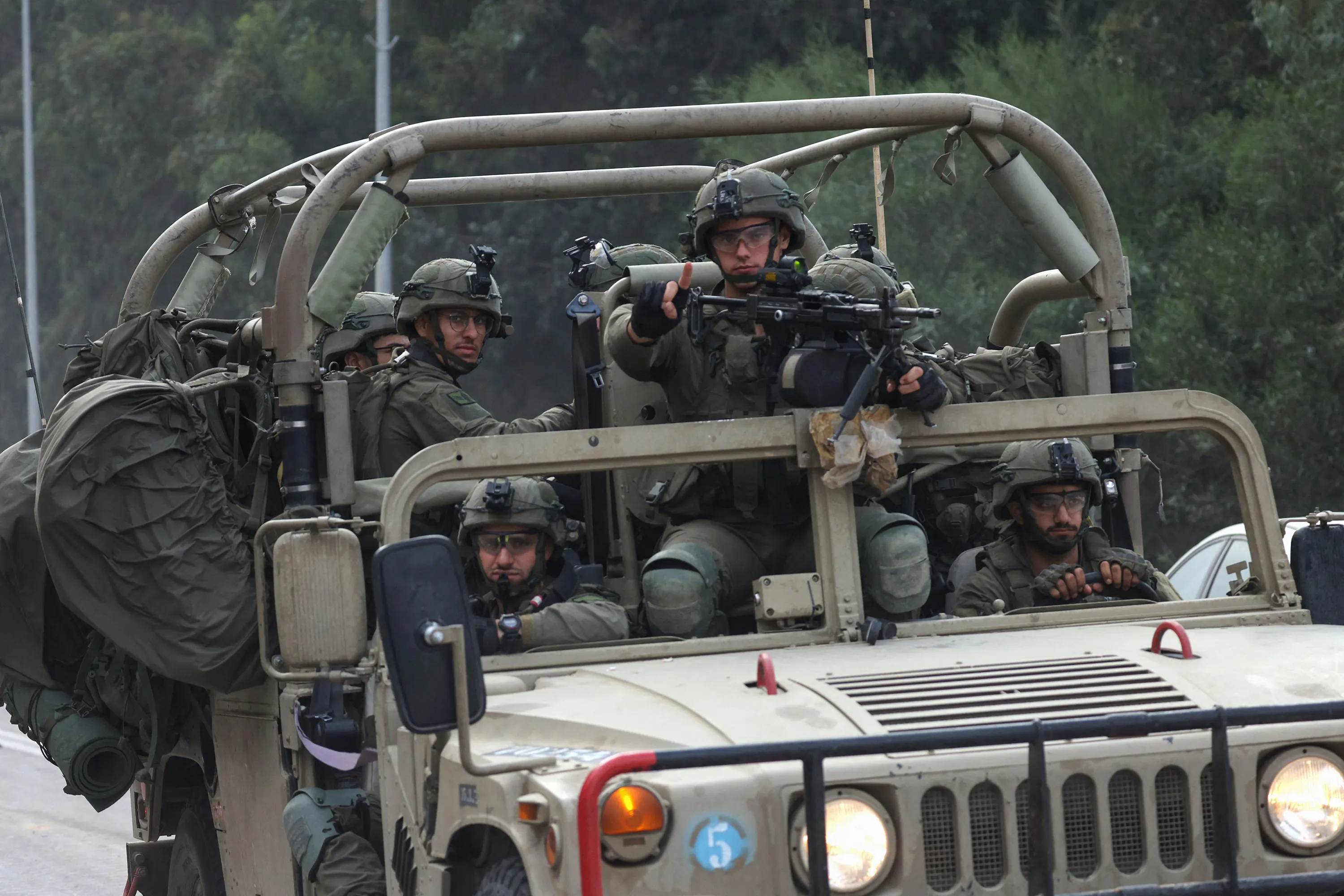 Israeli soldiers patrol a road near the border fence with Gaza on Oct. 10.