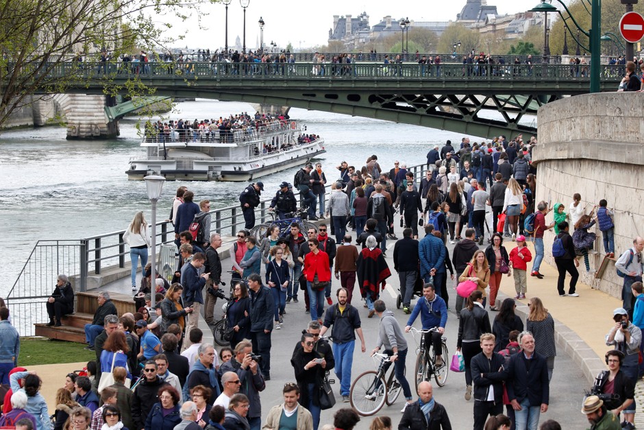 People walk on the right bank of the river Seine, officially prohibited to cars since October 21, 2016.