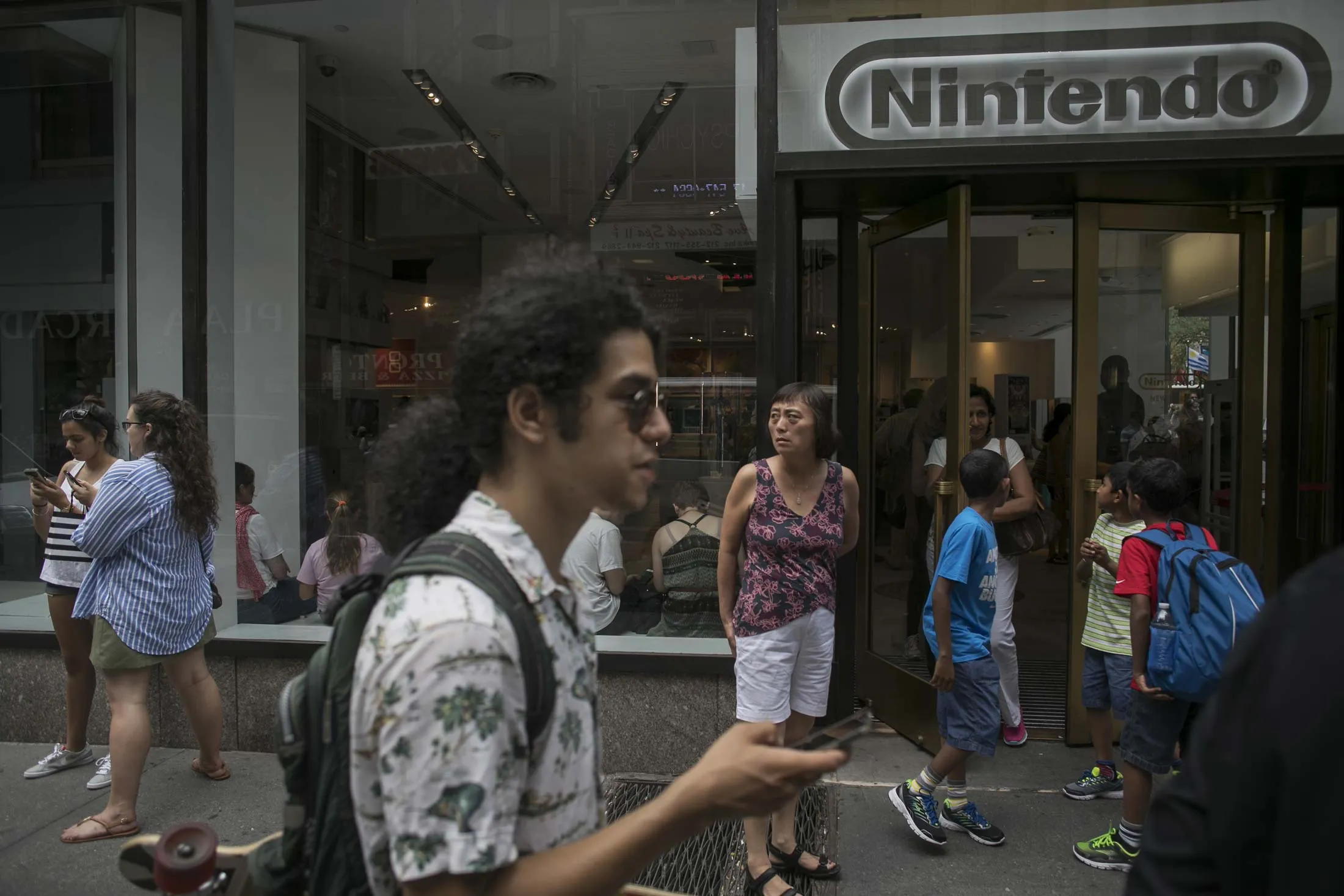 Playing Pokémon Go outside a Nintendo store at Rockefeller Center in New York.
