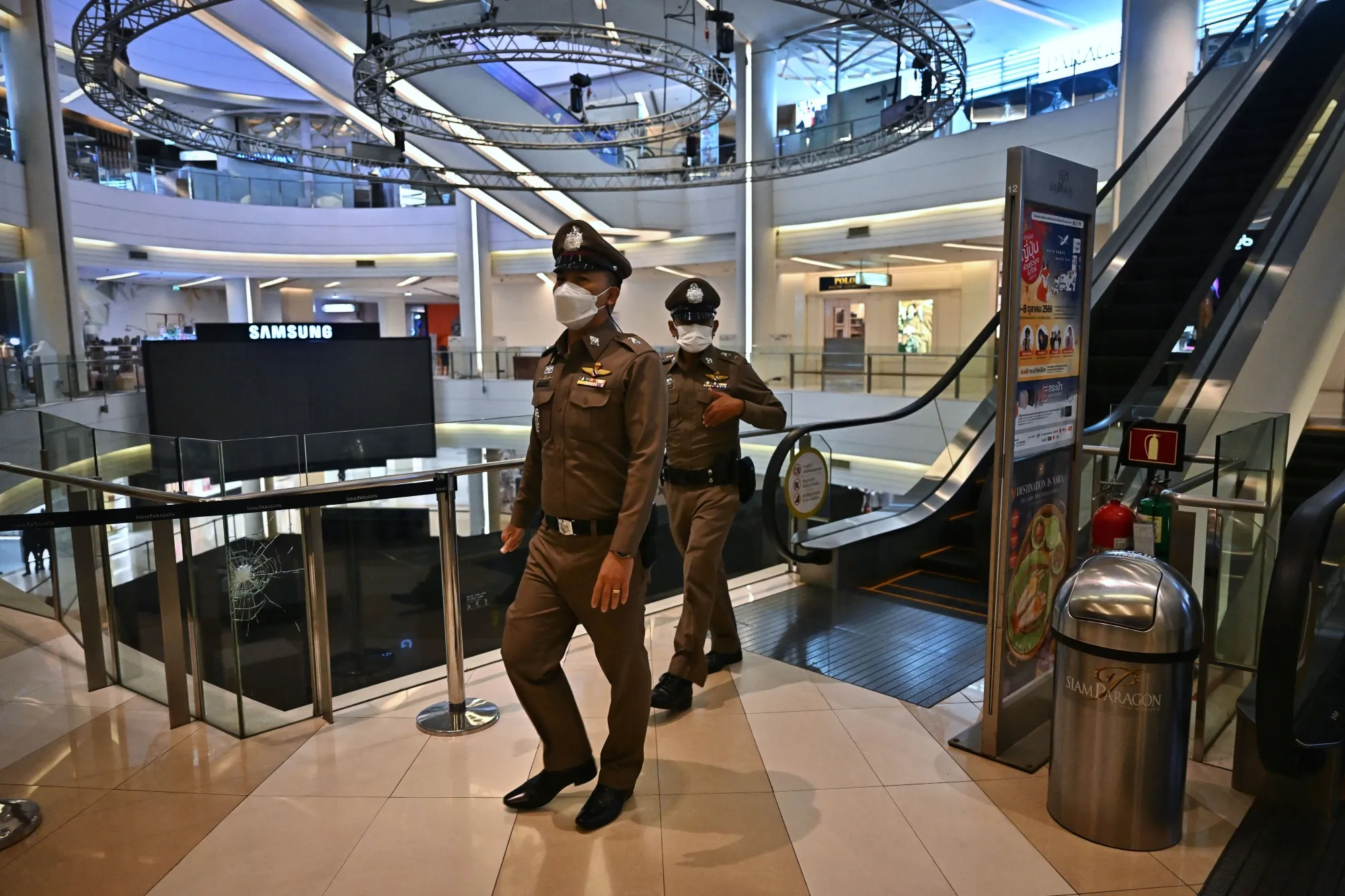 Thai police patrol inside the Siam Paragon shopping mall before opening in Bangkok on Oct. 4.