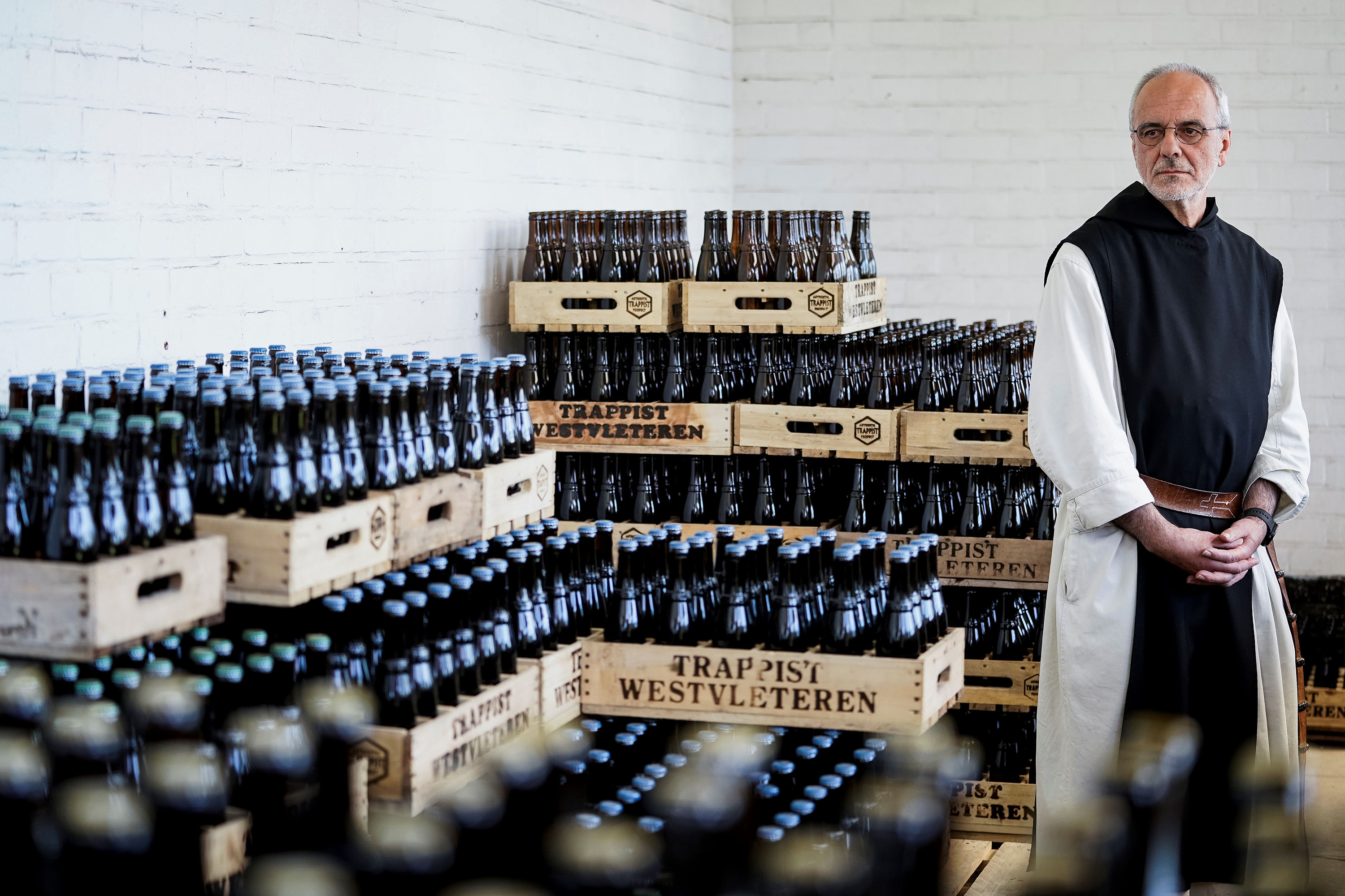 A monk poses by crates of Westvleteren beers at the shop at the Saint-Sixtus abbey, in Westvleteren, Belgium, on May 14.