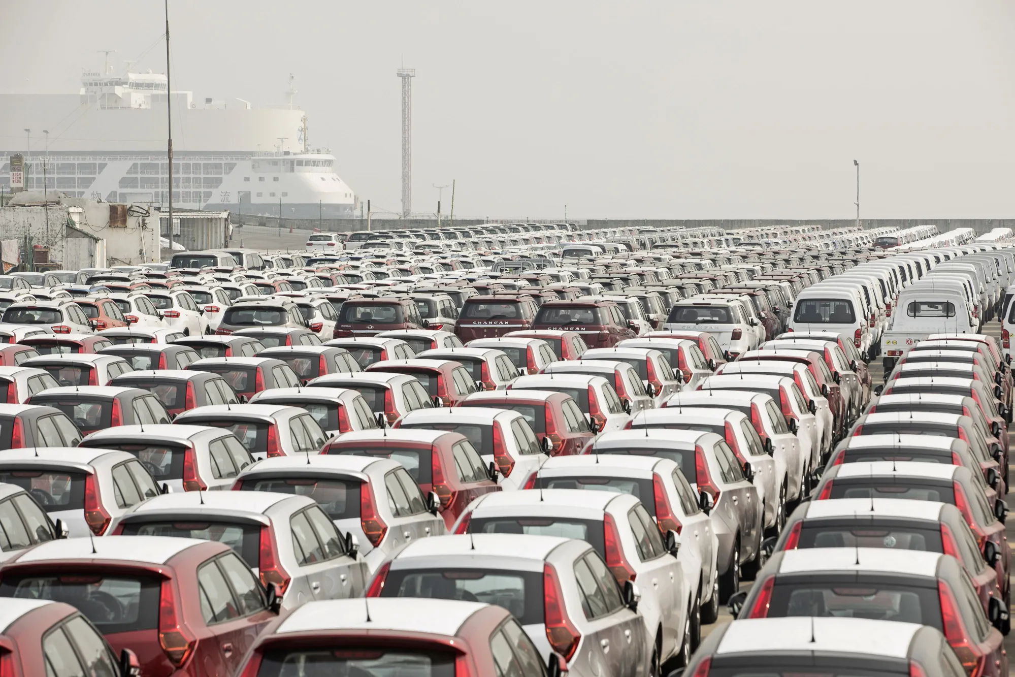 Vehicles at a Shipping Depot as China Says It Won't Submit to U.S. 'Threats' as Trade Talks Near
