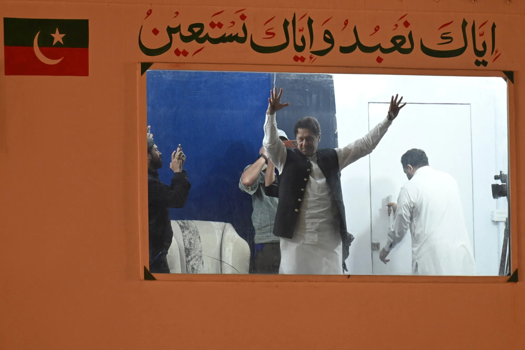 Imran Khan, behind a bulletproof shield, at a rally in Lahore, earlier in March.