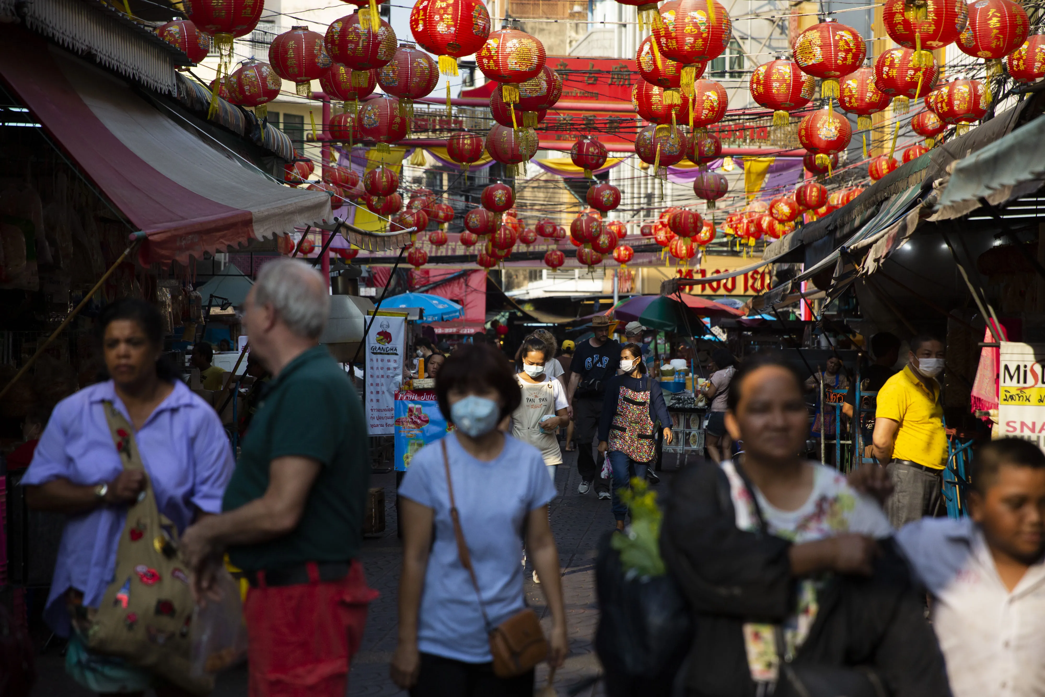 people pass through Chinatown in Bangkok, on Feb. 5.