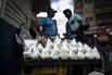A street vendor sells bagged portions of sugar, salt and beans at a stand in the Petare slum of Caracas, on April 14, 2018.
