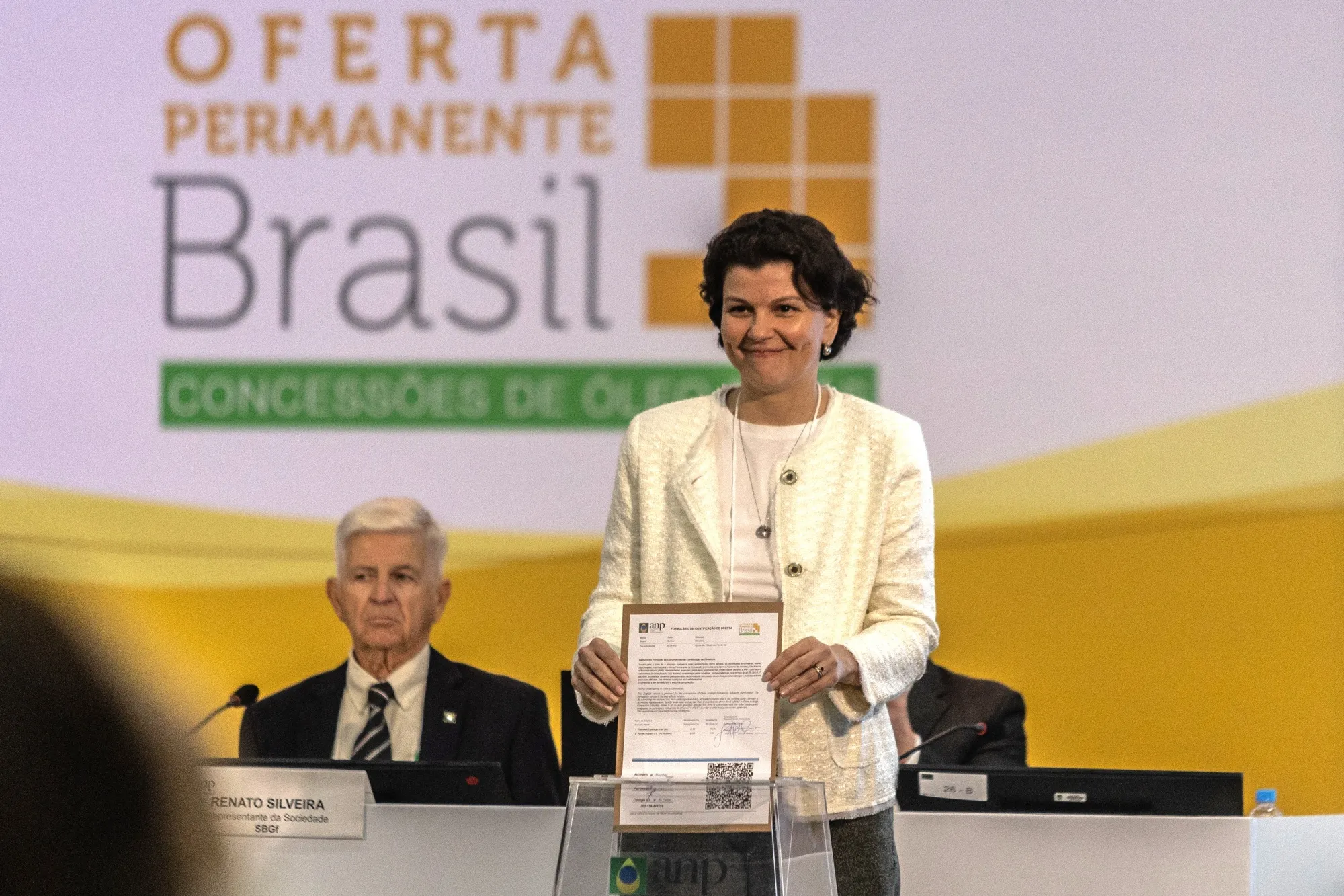 Camila Borges, a representative for Exxon Mobil Corp., presents a bid during a public session of the Agencia Nacional do Petroleo (ANP) oil concession offer in Rio de Janeiro on June 17.