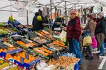 Shoppers at a fresh produce stall at a market in Madrid, Spain.