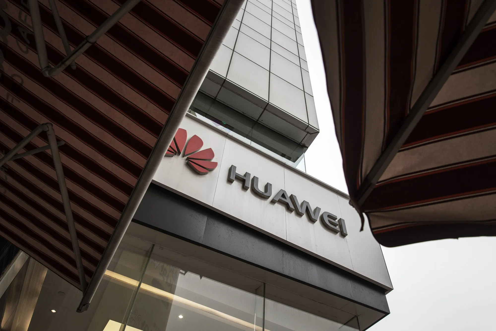 The Huawei Technologies Co. logo is displayed outside a store.
