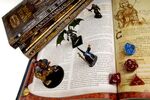 Books, dice, and figurines from Dungeons &amp; Dragons