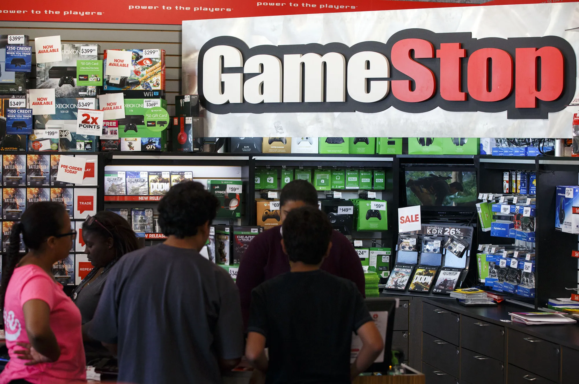 Customers shop at a GameStop store.