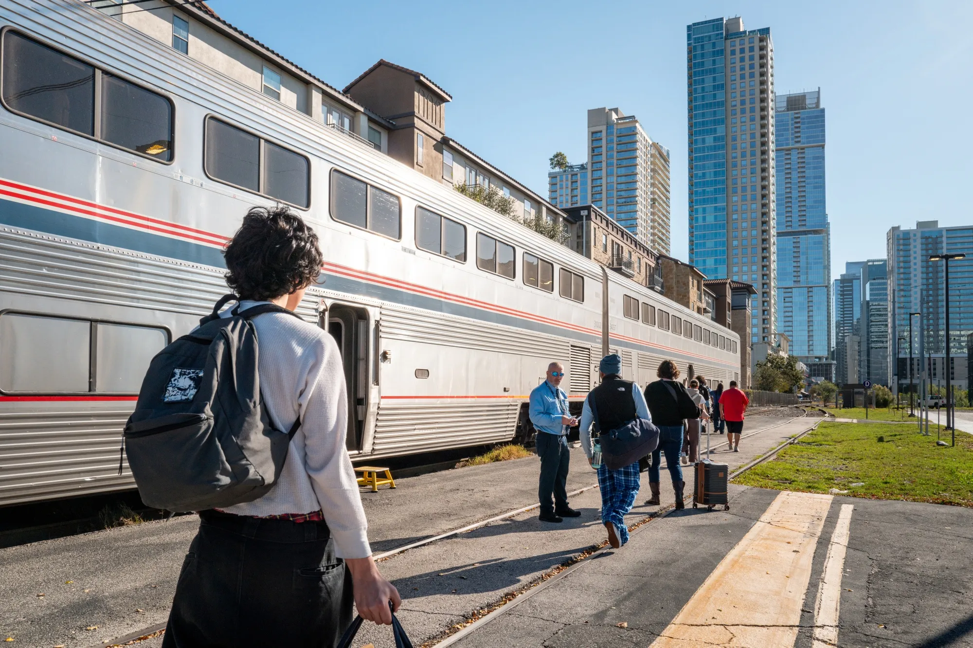 Travelers board an Amtrak train in Austin on Nov. 12.