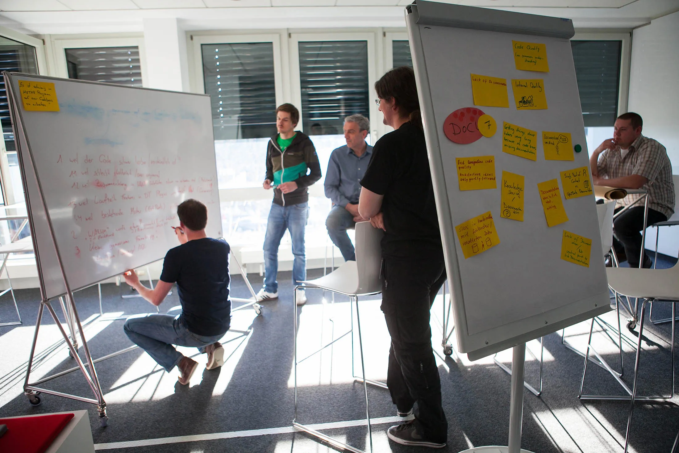 Employees use white boards as they brainstorm in an office inside the SAP AG headquarters in Walldorf, Germany.
