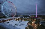 ICON Park attractions, The Wheel, left, Orlando SlingShot, middle, and Orlando FreeFall, right, are shown in Orlando, Fla., on Thursday, March 24, 2022.   A 14-year-old boy fell to his death from a ride at an amusement park in Orlando, sheriff's officials said. Sheriff's officials and emergency crews responded to a call late Thursday at Icon Park, which is located in the city's tourist district along International Drive. The boy fell from the Orlando Free Fall ride, which opened late last year.(Stephen M. Dowell /Orlando Sentinel via AP)