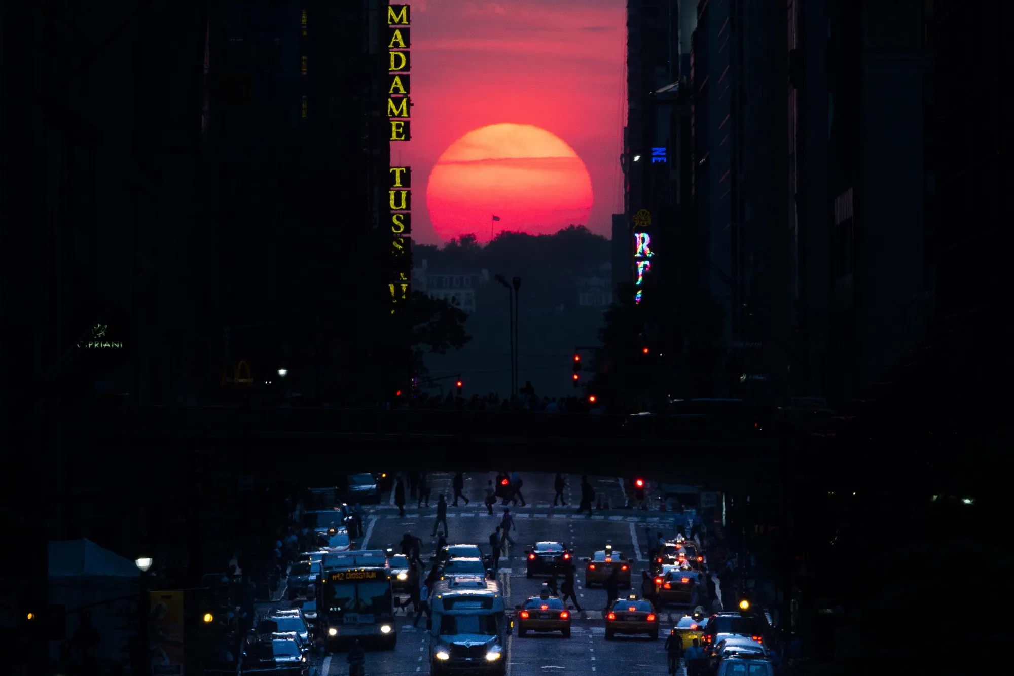The sun sets along 42nd Street in Manhattan during an annual phenomenon known as "Manhattanhenge," when the sun aligns perfectly with the city's transit grid. (AP Photo/John Minchillo, File)