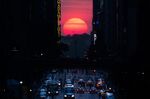 The sun sets along 42nd Street in Manhattan during an annual phenomenon known as "Manhattanhenge," when the sun aligns perfectly with the city's transit grid. (AP Photo/John Minchillo, File)