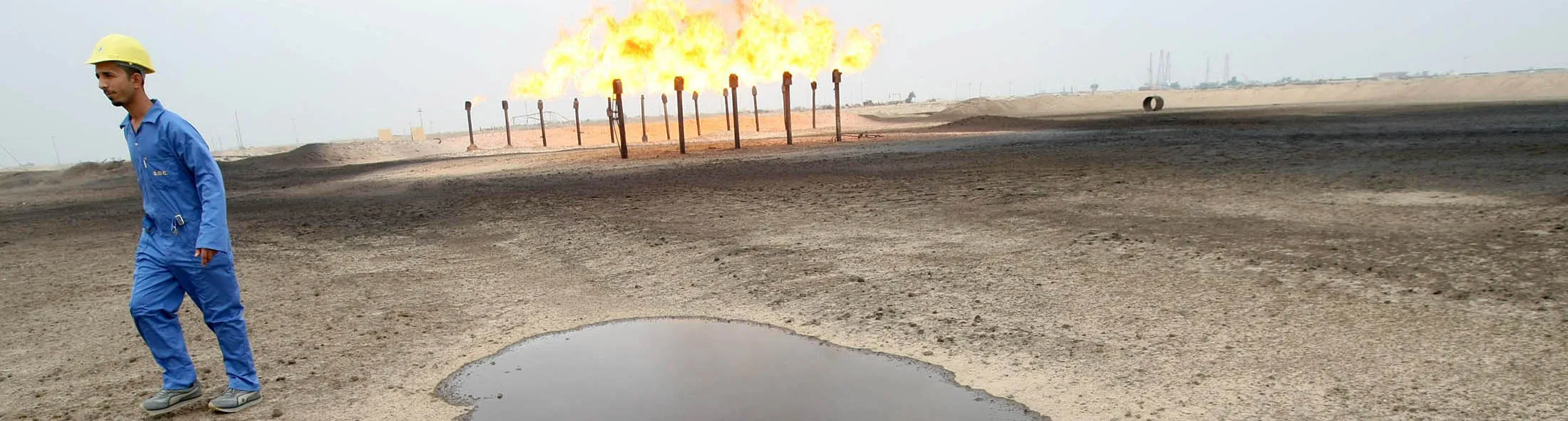 An engineer walks across the Zubair oil field in southern Iraq on January 21, 2010. Zubair produces around 227,000 barrels of oil per day, according to information released by Iraq's oil ministry last year, and has reserves of around four billion barrels. A consortium led by Italian energy giant ENI -including China's Sinopec, Occidental Petroleum Corporation of the United States and Korea Gas Corporation of South Korea- have agreed to terms with the Iraqi government to exploit the Zubair. AFP PHOTO / ESSAM AL-SUDANI (Photo credit should read ESSAM -AL-SUDANI/AFP/Getty Images)
