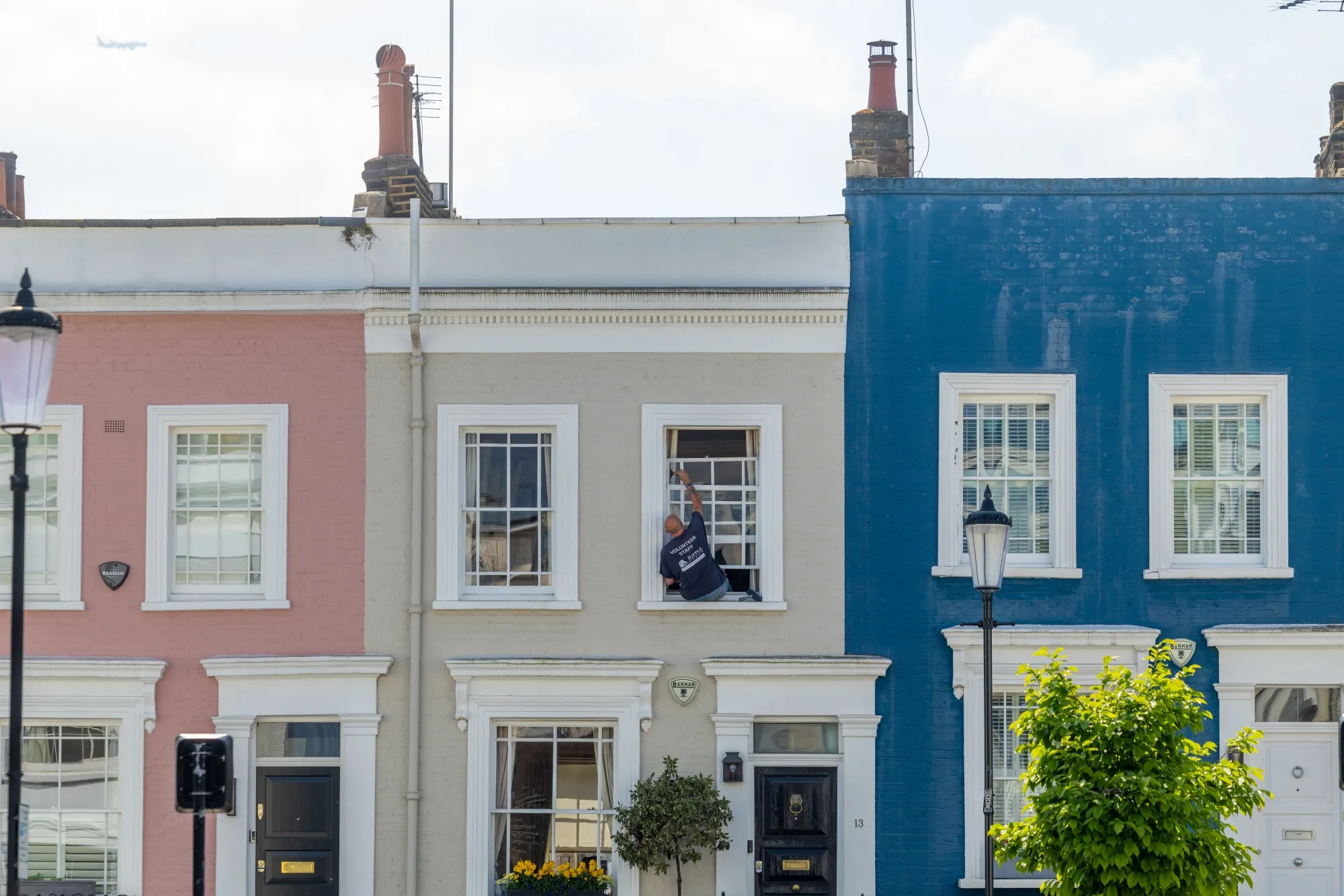 A worker cleans a window of a residential property in the Kensington and Chelsea district in London.