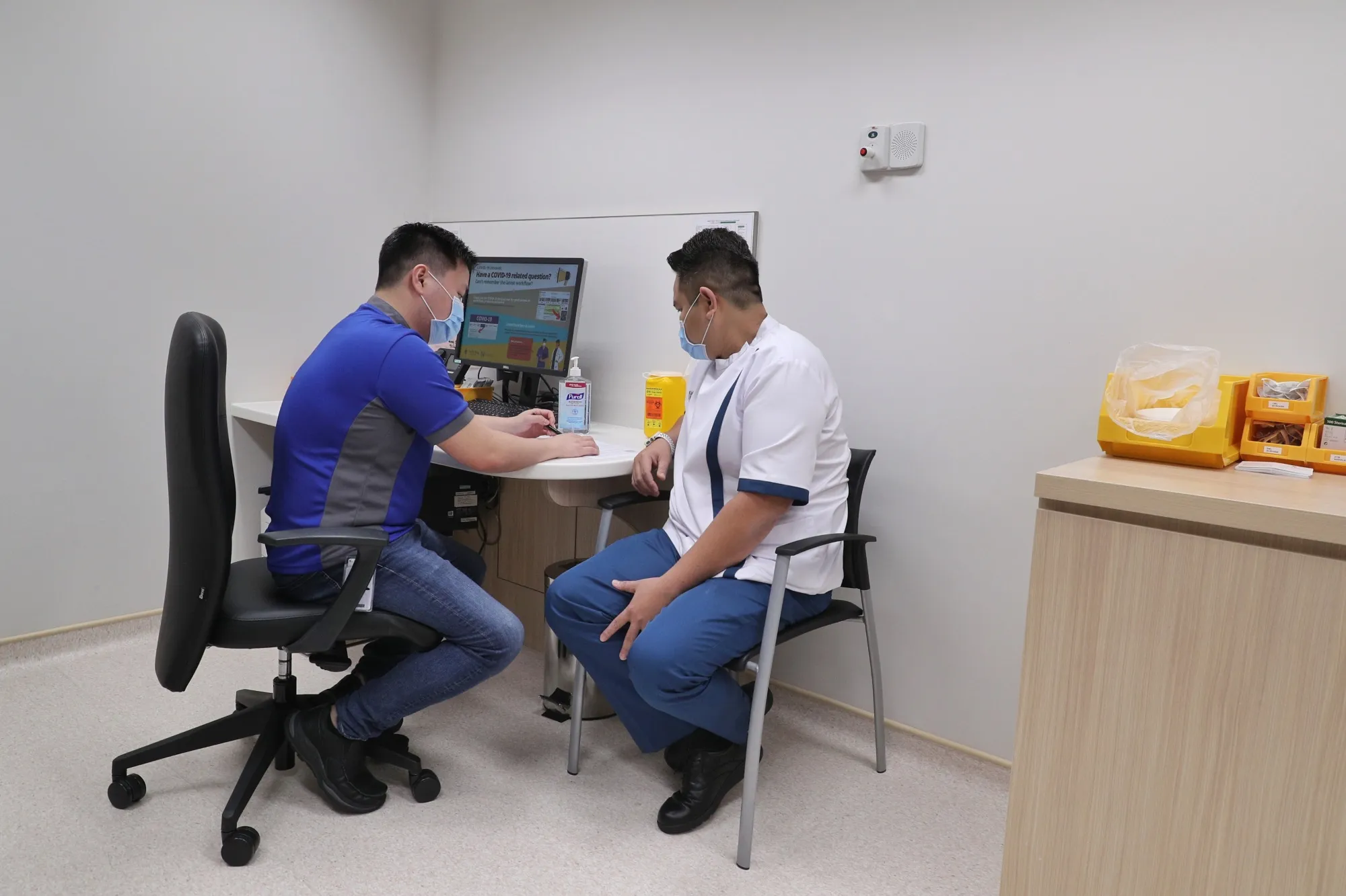 A senior staff nurse at NCID is vaccinated in Singapore on Dec. 30.