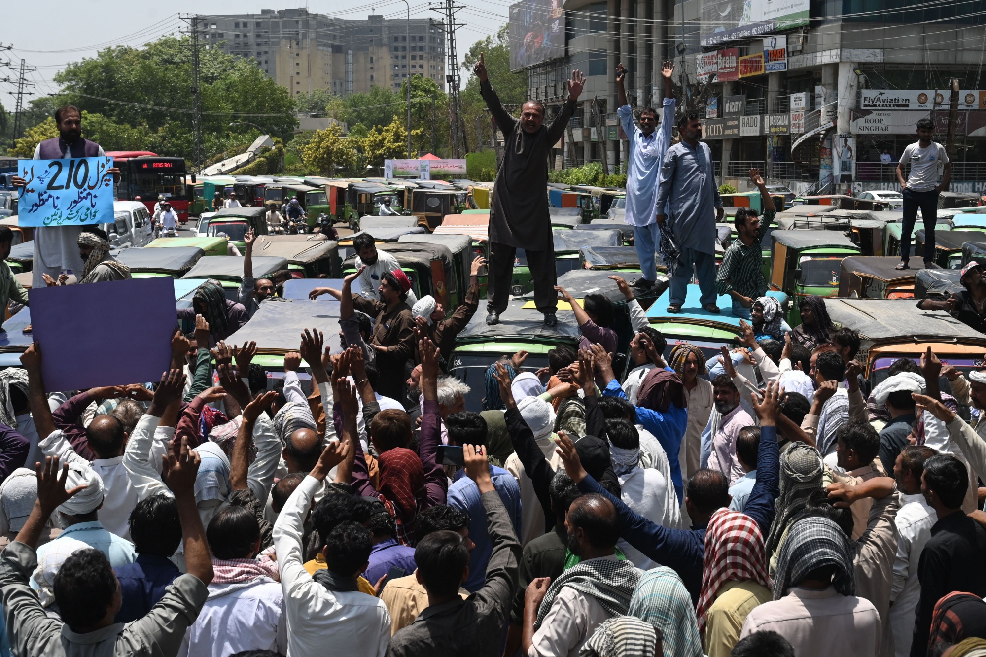 Autorickshaw drivers shout slogans during an anti-government demonstration to protest against&nbsp;inflation and fuel price hikes in Lahore, Pakistan.