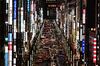 Night scene of a street in Tokyo's Ginza district lit by numerous signs on buildings