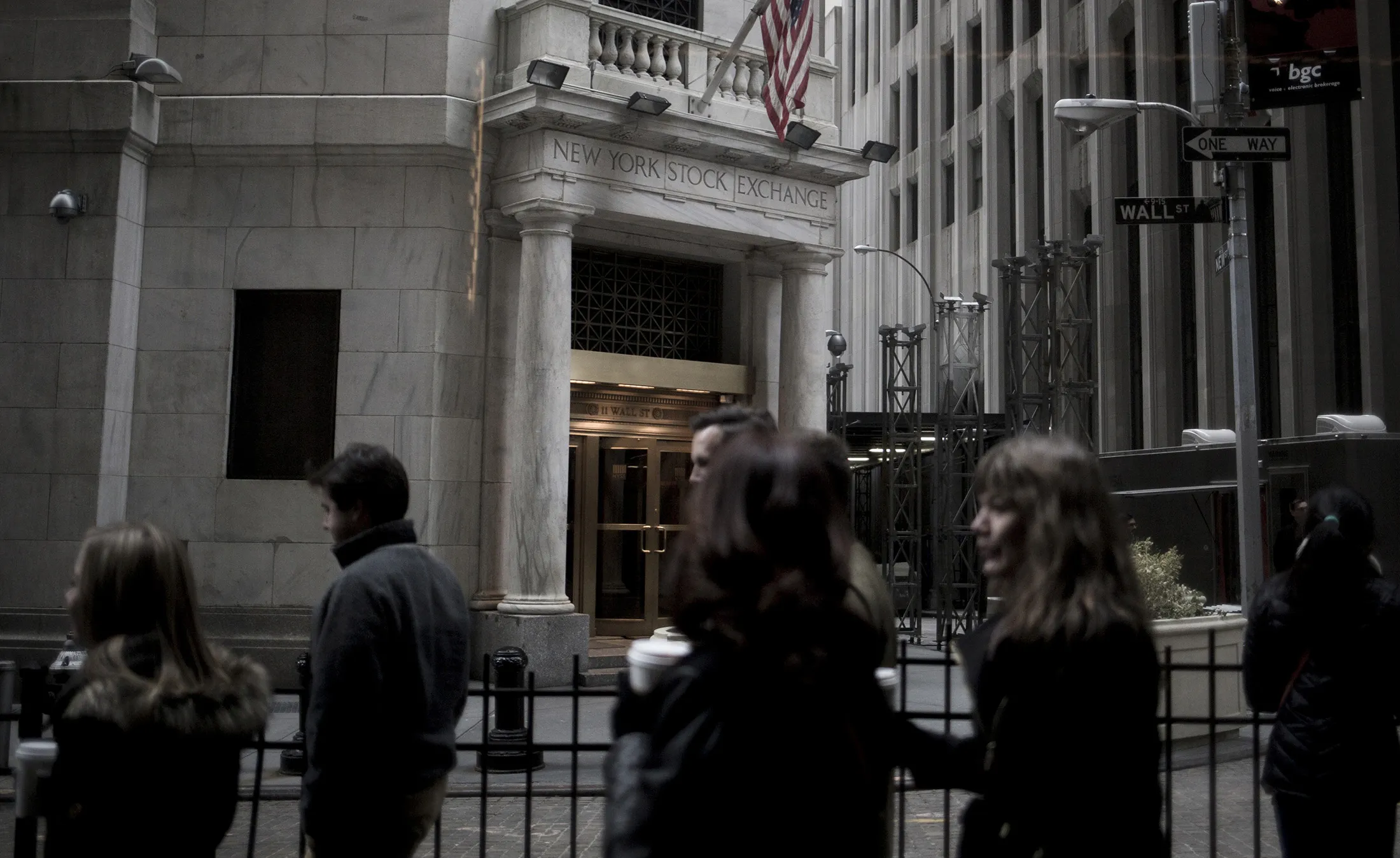 Pedestrians walk past the New York Stock Exchange.
