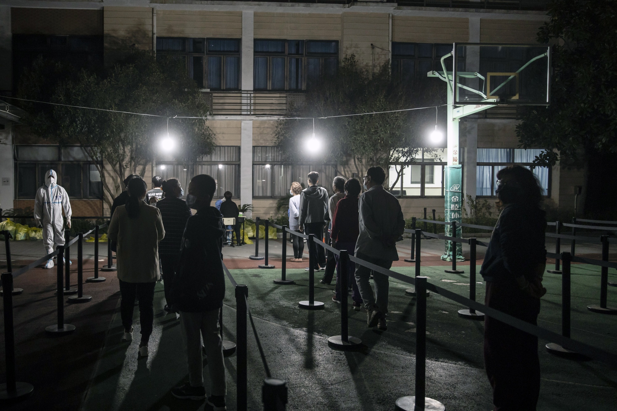 Residents line up to be tested at a neighborhood placed under lockdown in Shanghai, on March 16.