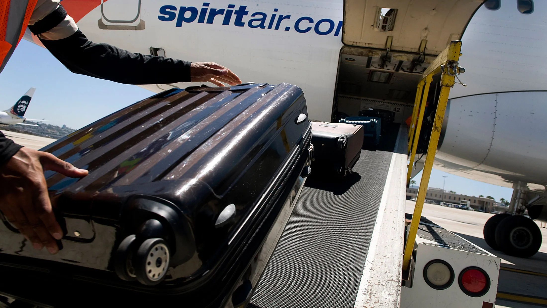 Ground crews load baggage onto a Spirit Airlines planes at the San Diego International Airport.
