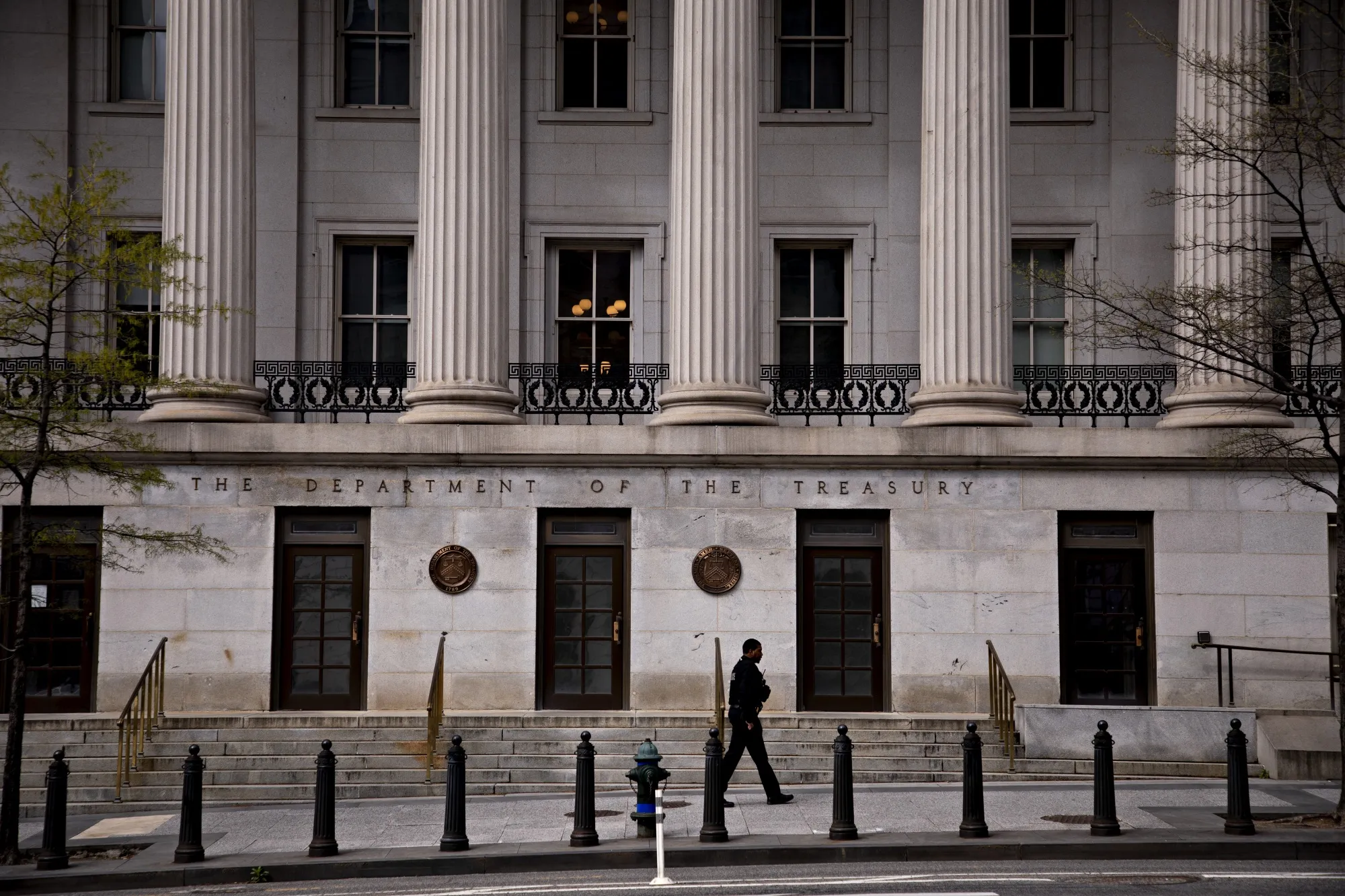 A Secret Service officer walks past the U.S. Treasury building in Washington on April 1.