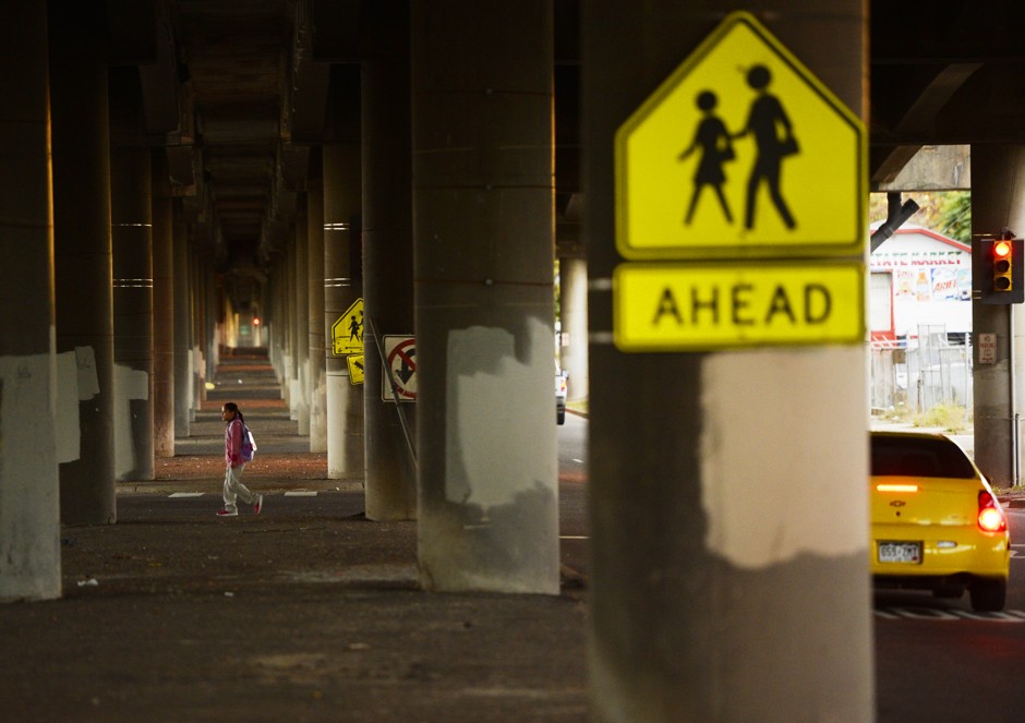 A young girl walks under Interstate 70 on her way to Swansea Elementary School.