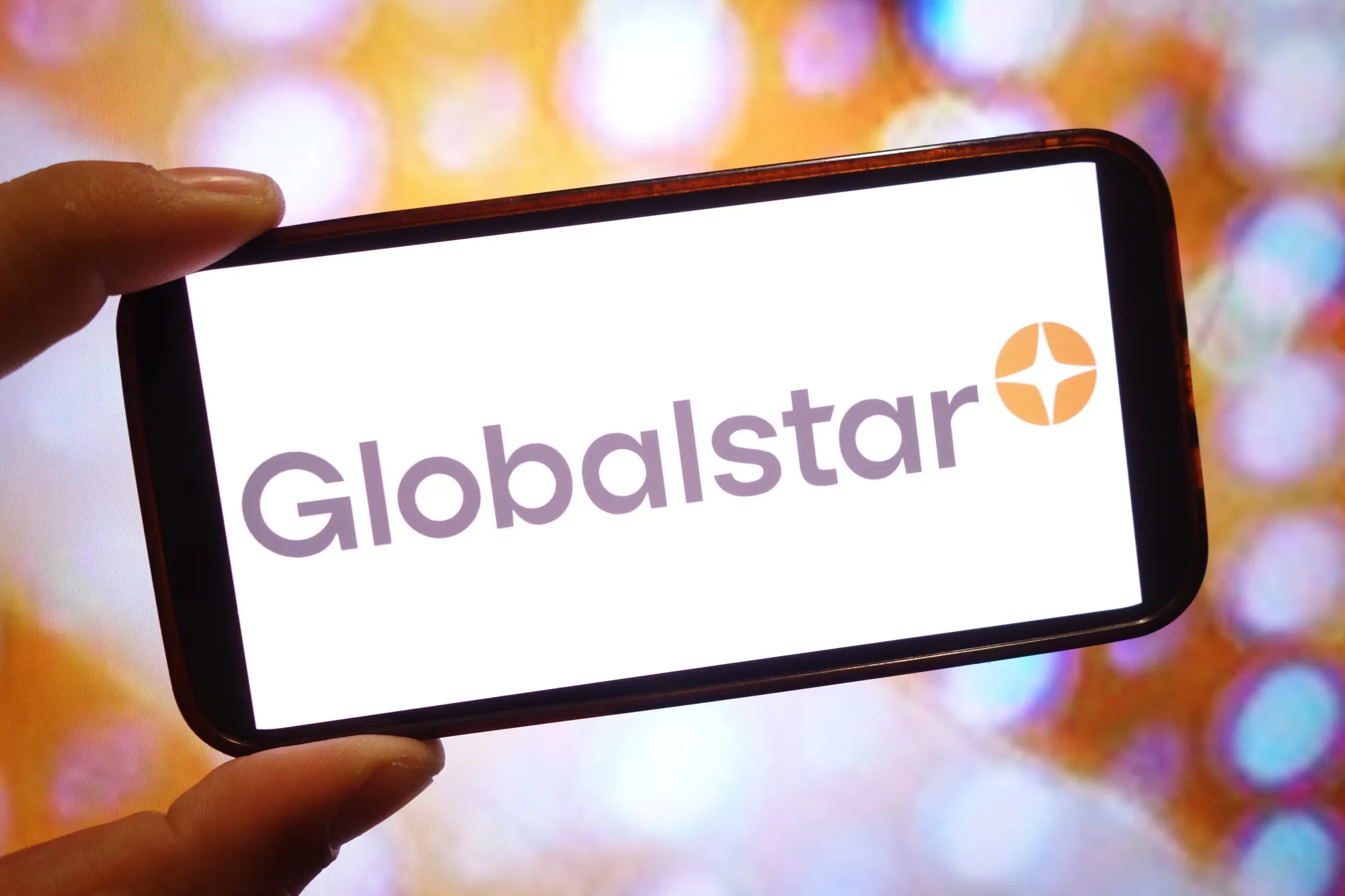 In this photo illustration, a Globalstar company logo is