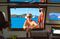 A customer waits for her pizza at the boat’s window.