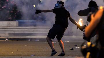 A protester clashes with riot police in front of the Greek Parliament in Athens on July 15, 2015.