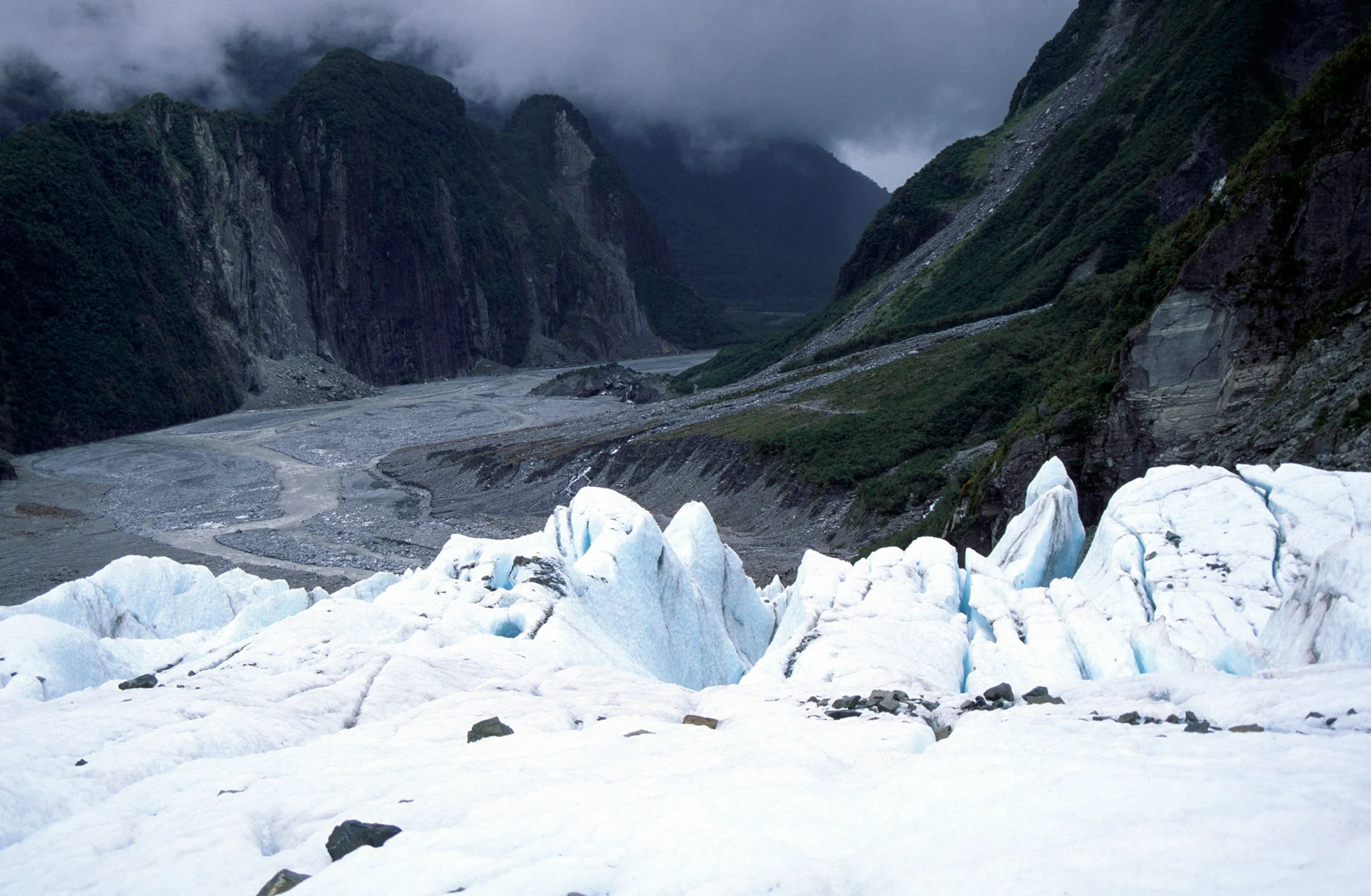 View down the U shaped glacial trough from near the front of the Fox glacier, New Zealand