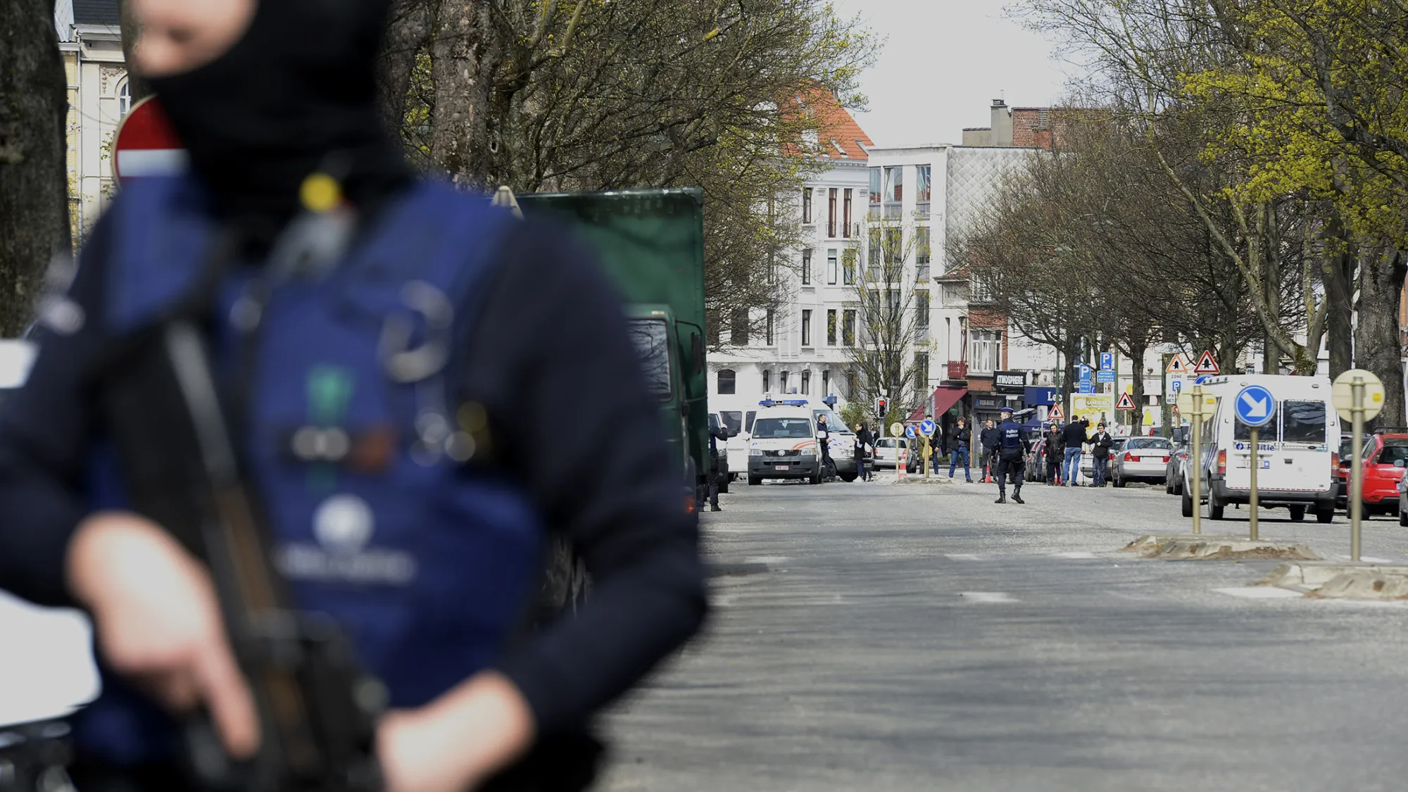 Belgian police officers stand guard in a street in Etterbeek, Brussels
