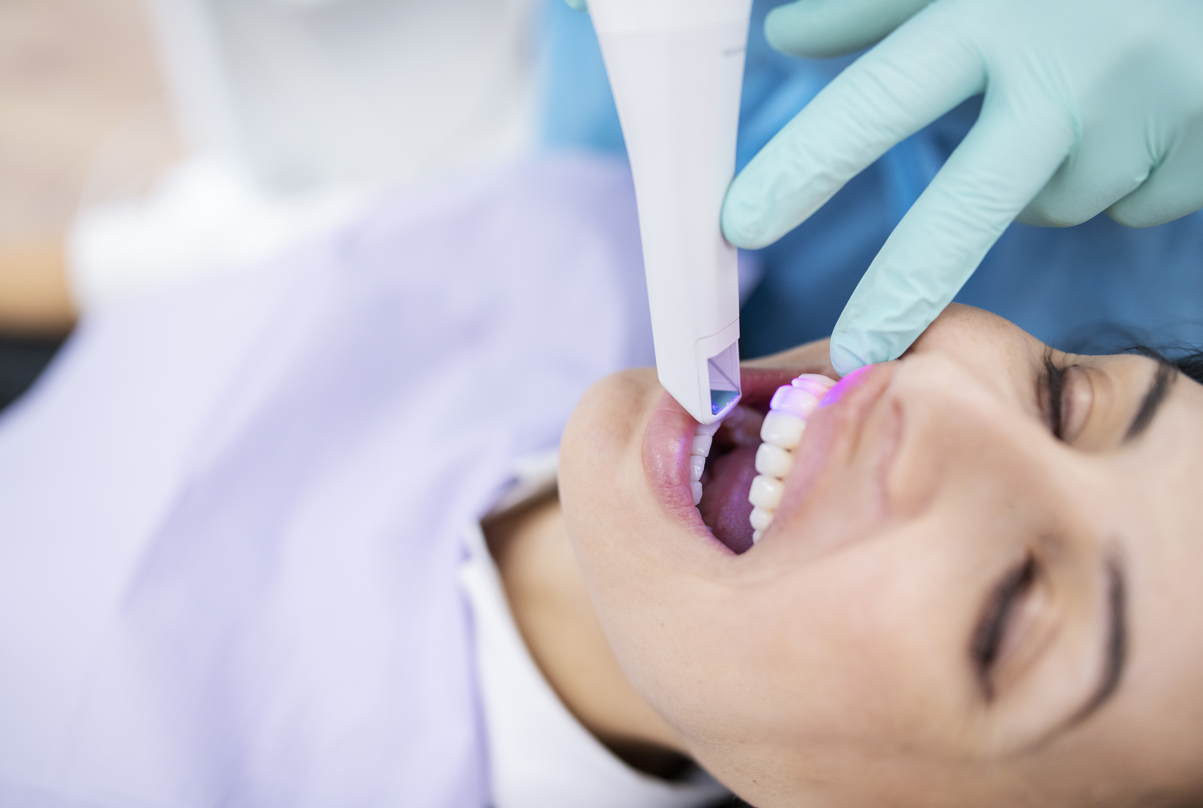 A dental scanner being used by a dentist.