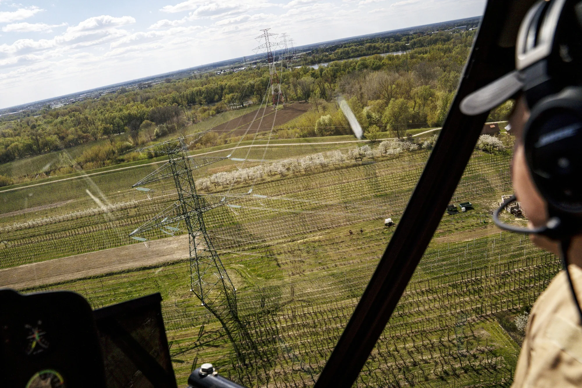 A Robinson R66 chopper flies over high-voltage power lines while monitoring the grid between&nbsp;between&nbsp;the Kozienice Power Station and Warsaw on April 21.