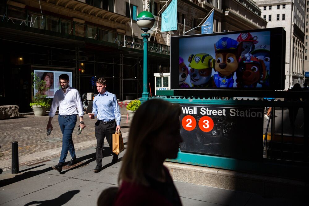 Pedestrians pass a Wall Street subway station near the New York Stock Exchange (NYSE) in New York, U.S., on Tuesday, Sept. 7, 2021. 