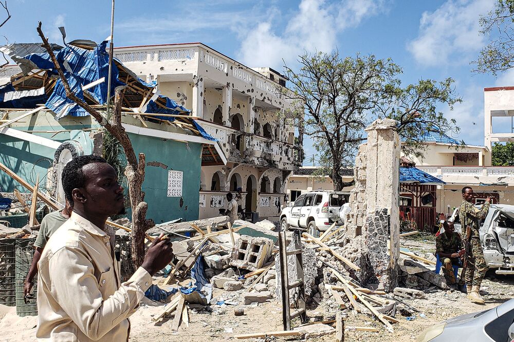 A man passes in front of the rubble of the hotel in Kismayo on July 13. 
