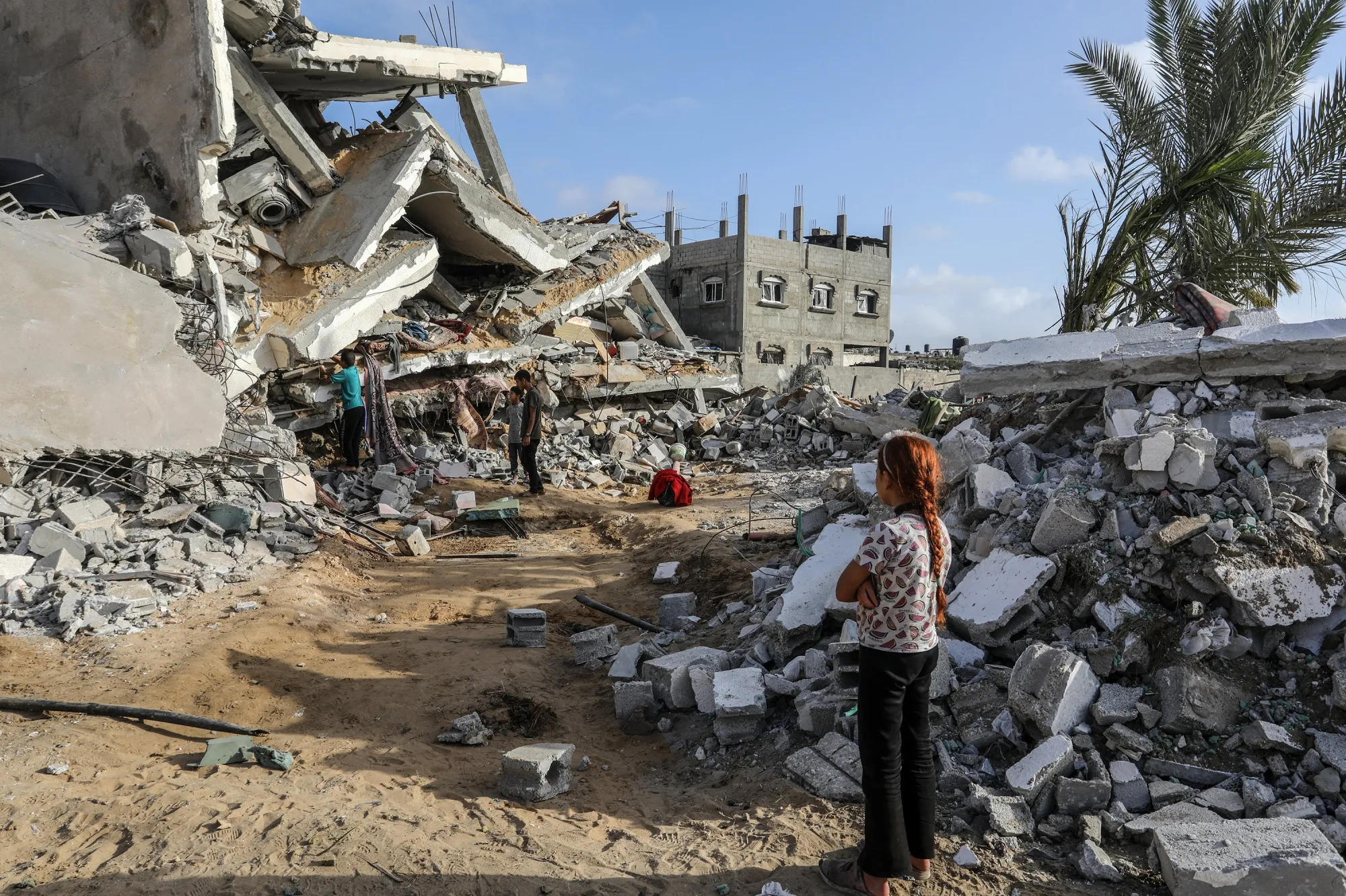 Civil defense teams and residents carry out search and rescue efforts after an airstrike&nbsp;in Rafah on April 21.
