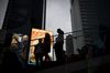 People stand in Times Square in New York, U.S., on Thursday, March 12, 2020. New York, the financial and cultural capital of the U.S., folded in on itself Thursday amid the coronavirus pandemic.