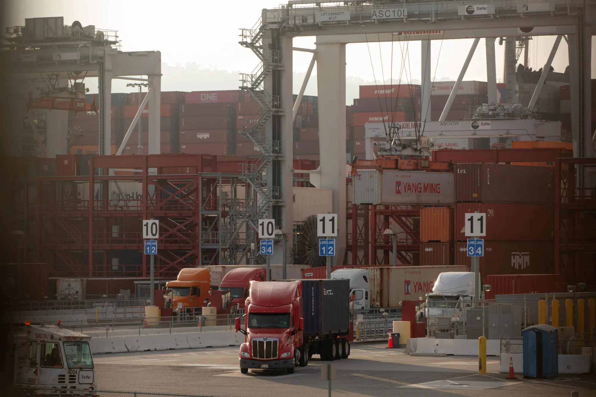Trucks exit the Port of Los Angeles in Los Angeles on Nov. 16.