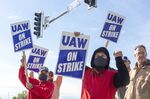 Workers hold signs during a strike outside the John Deere Des Moines Works facility in&nbsp;Iowa, on&nbsp;Oct. 15.