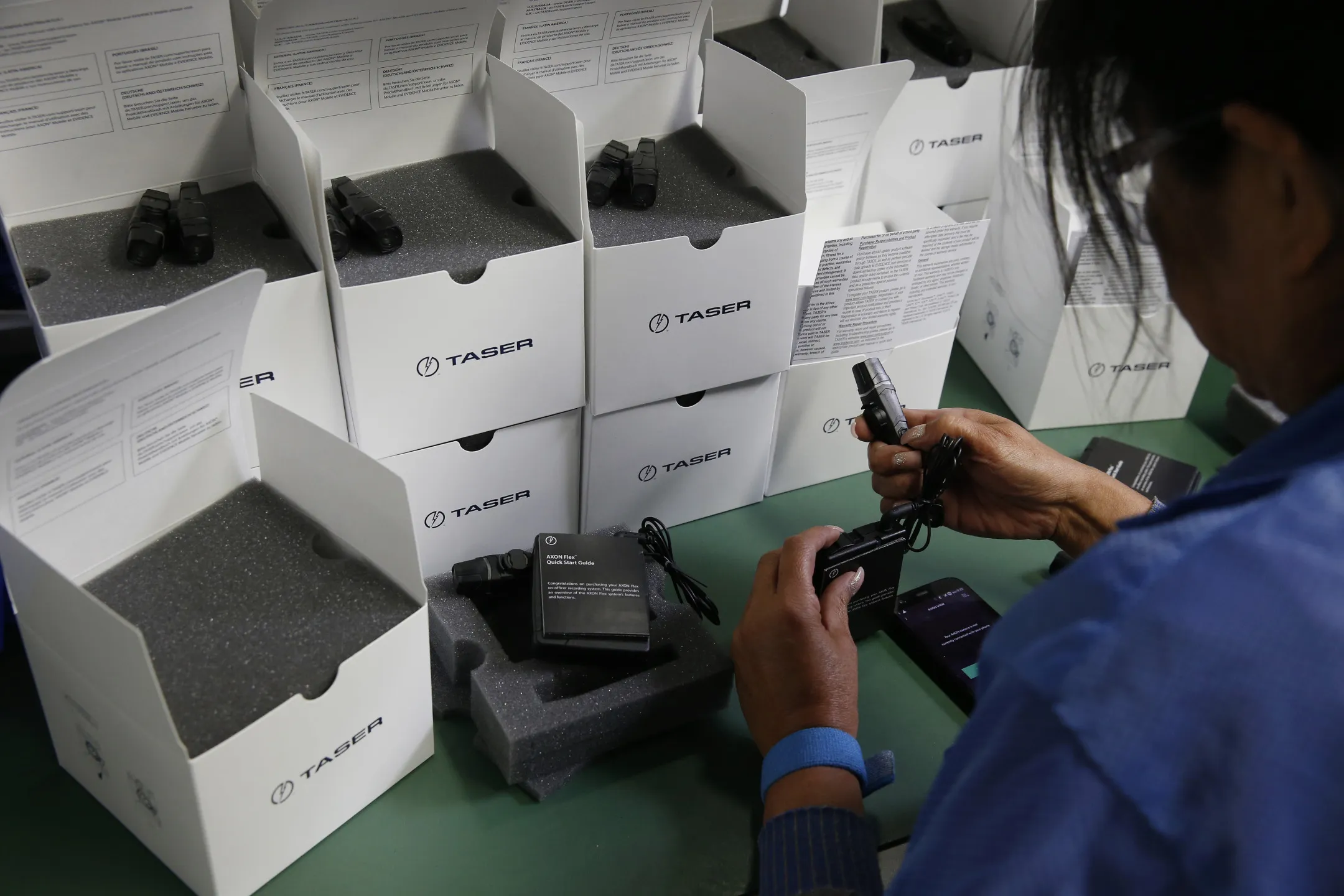 An employee tests and packages AXON police body cameras at the Taser International Inc. manufacturing facility in Scottsdale, Arizona.