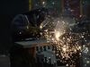 A worker welds a structural beam during production at a steel facility in West Jordan, Utah.