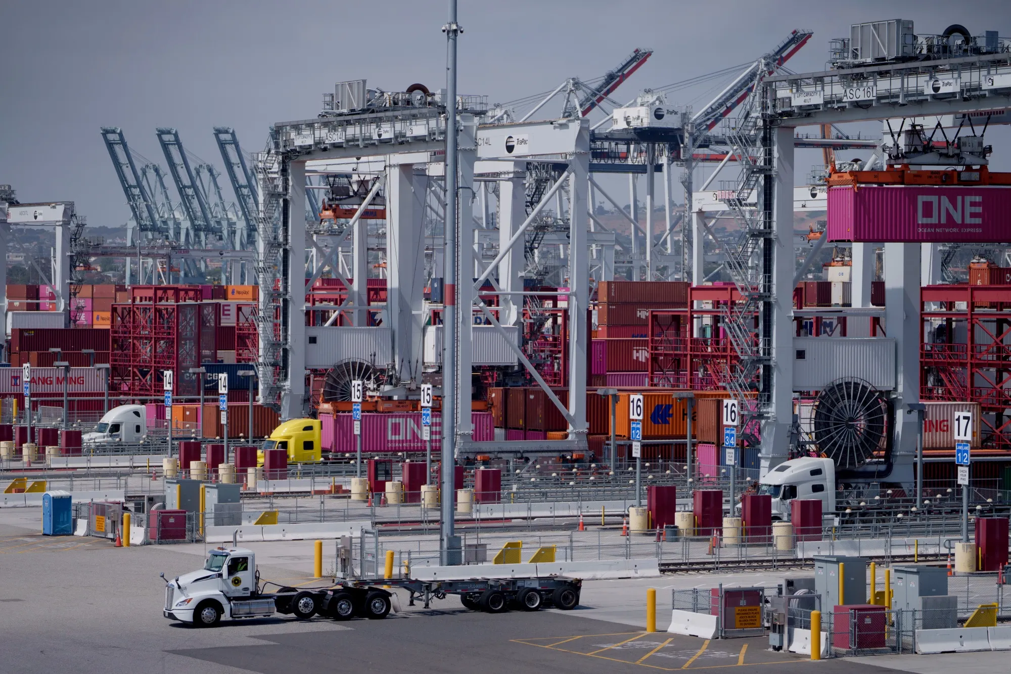 Trucks and cargo container loaders at the Port of Los Angeles.