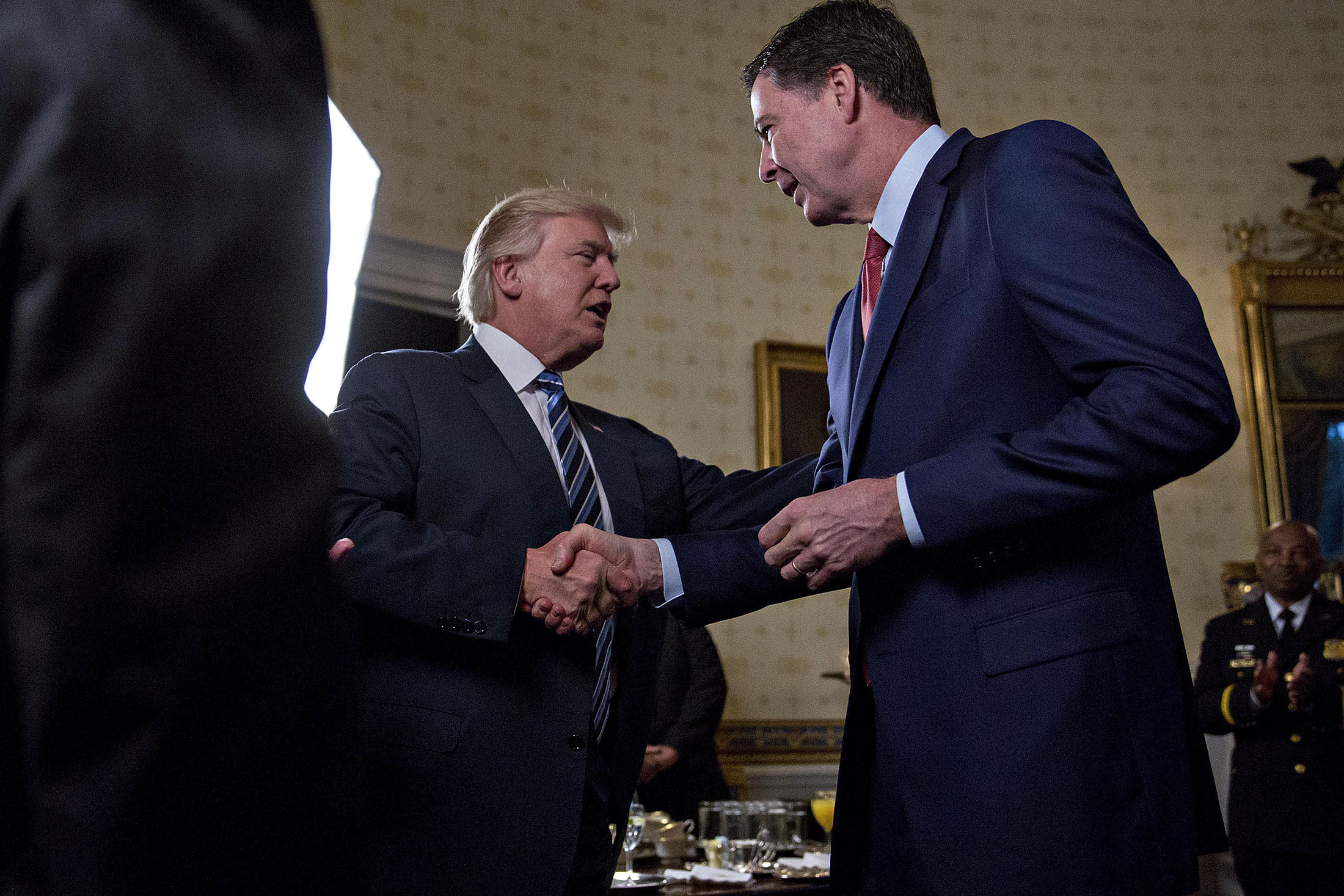 Trump Gives FBI’s Comey a Handshake and Hug Amid Investigations - Bloomberg