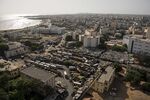 Vehicles sit at a parking lot in the Plateau district of Dakar, Senegal.